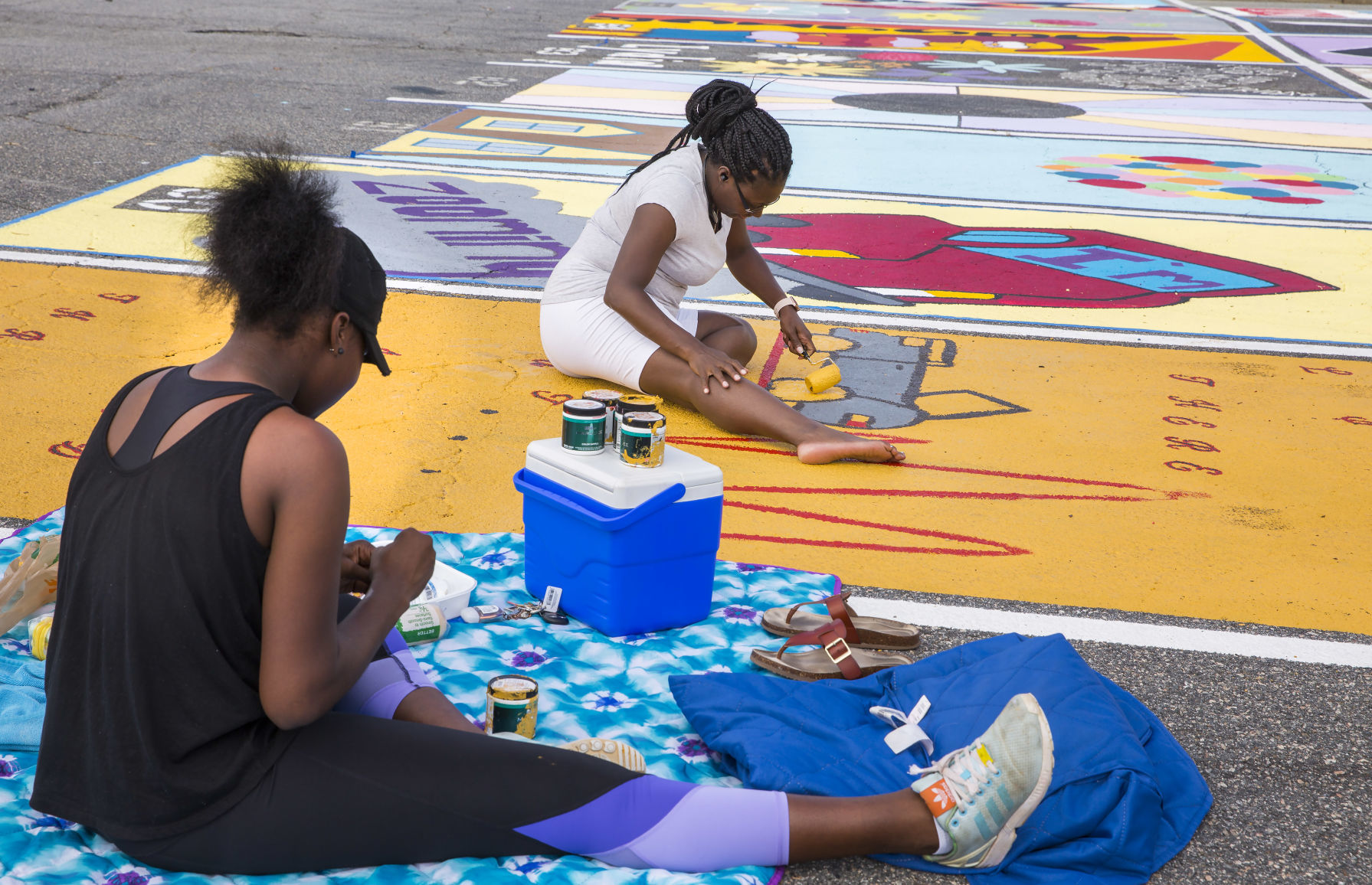 Students painting their parking spaces